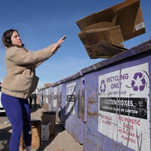 DENVER, CO - DECEMBER 6 : Olivia Westerman drops off the cardboards into the dumpster for recycling at the City and County of Denver Recycling Processing Center in Denver, Colorado on Tuesday, December 6, 2022. (Photo by Hyoung Chang/The Denver Post)